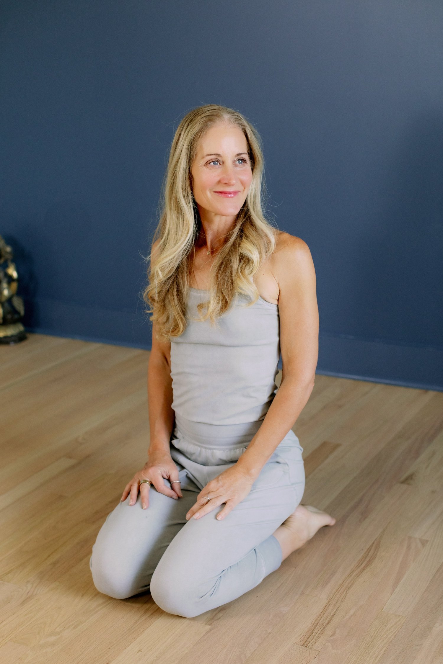 kari seated in virasana, hands in mudra